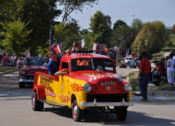 Red and yellow car with flame decals and Shriners decals